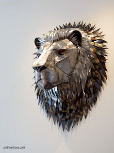 a metal sculpture of a bear's head on a wall