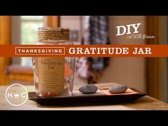 a bottle and some rocks on a table with the words diy thanksgiving gratitude jar