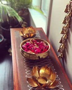 two bowls filled with flowers on top of a table