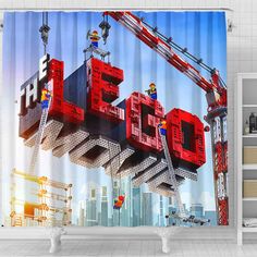 a shower curtain with the word lego spelled out in red blocks on top of a construction site