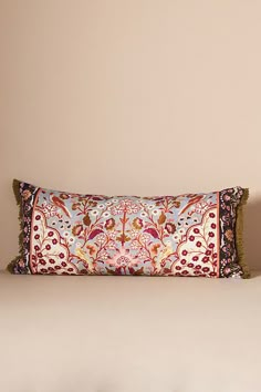 a decorative pillow on top of a bed