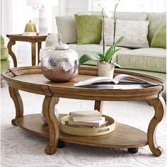 a living room with a couch, coffee table and two end tables on carpeted flooring