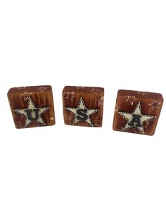 two wooden cufflinks with stars and the letter u s on each one side