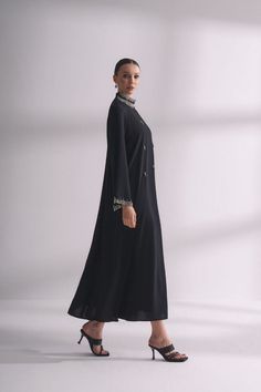 Step out in style and elegance with our Jewel neck with rhinestone Abaya. This beautiful and modest garment features a stunning jewel neck design embellished with rhinestones, making it perfect for special occasions or everyday wear for Muslim women looking for a touch of luxury. Product Features: - Jewel neck design with rhinestones adds a touch of glamour to your look. - Made from high-quality, comfortable fabric for all-day wear. - Modest and elegant design is perfect for a range of occasions Elegant Embellished Long Maxi Dress, Elegant Long Embellished Maxi Dress, Elegant Long Abaya With Dabka Work, Elegant Embellished Thobe For Eid, Festive Elegant Maxi Length Thobe, Elegant Long Dress With Mirror Work, Elegant Embellished Maxi Length Thobe, Elegant Long Dresses With Mirror Work, Elegant Floor-length Kaftan With Mirror Work