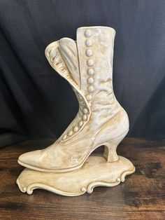 a pair of white shoes sitting on top of a wooden table