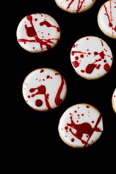 some cookies with red and white icing on them