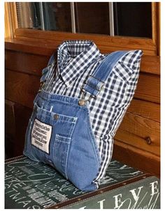 a denim bag sitting on top of a stack of books