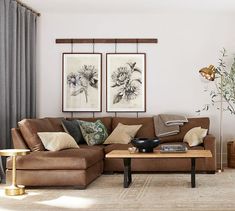 a living room filled with furniture and paintings on the wall above it's coffee table