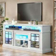 a living room with a flat screen tv mounted on the wall above it's entertainment center