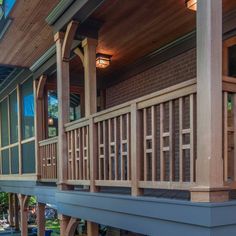 the front porch of a house with wooden railings