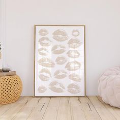 a white room with a wooden floor and a framed photograph on the wall next to a plant