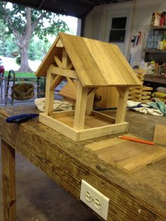 a bird house sitting on top of a wooden table