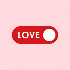 a red button with the word love written on it and a white dot in the center