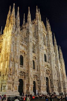 people are standing in front of the cathedral