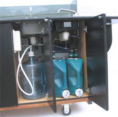 an open cabinet with two different types of water and gas bottles on wheels, in front of a white background