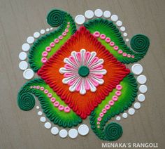 an intricately designed design on the floor with circles and dots around it in red, green, white and pink colors