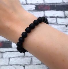 What size is the bracelet? This bracelet is one size fits all - elastic string used.  What material are the beads? -8mm Matte Black Beads Can I wear it in water? Yes!  When was it made? Jewelry is made to order so the beads are always fresh and new! Check us out at: WWW.WOOLANDPEPPERCO.COM WWW.INSTAGRAM.COM/WOOLANDPEPPERCO Everyday Black Beaded Bracelets With Round Beads, Casual Black Beads Wristband Gift, Casual Black Beads Stretch Bracelet Gift, Casual Black Beads Stretch Bracelet, Casual Black Beaded Bracelets With Round Beads, Minimalist Black Stretch Bracelet With Round Beads, Casual Stretch Bracelet With 8mm Beads, Casual Black Beaded Bracelets With Large Beads, Casual Black Beaded Bracelet With Large Beads