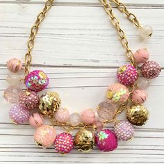 "Hot pinks, blush and gold tone statement necklace bursting with a fun mix of sparkly pave and shiny sequin beads. Beads are securely wired wrapped to perfection on our signature gold-plated sturdy cable chain with lobster clasp. 18\"L with 3\" extension. Handmade in USA." Party Necklaces With Lobster Clasp And Round Beads, Rose Gold Beaded Necklace For Party, Pink Large Beaded Jewelry For Parties, Pink Large Beads Jewelry For Party, Pink Large Beads Necklace For Party, Pink Beaded Necklace With Large Beads For Party, Festive Pink Beaded Necklace, Festive Pink Necklaces With Colorful Beads, Pink Beaded Necklace For Party