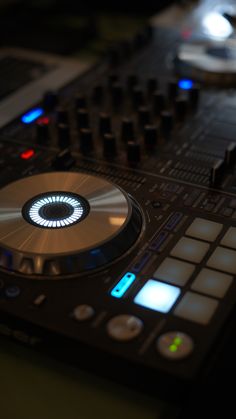 a close up of a dj's turntable with buttons and lights on it