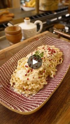 macaroni and cheese on a plate with a video player in the background,