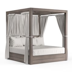 a canopy bed with white sheets and pillows