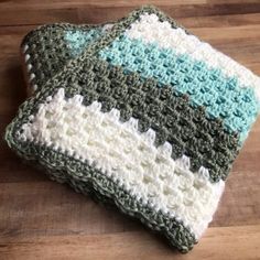 a crocheted dishcloth sitting on top of a wooden table