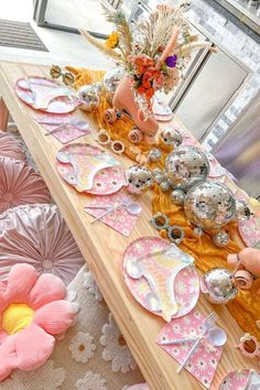 a table with plates and flowers on it