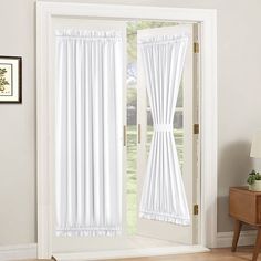 white curtains hanging on the side of a door