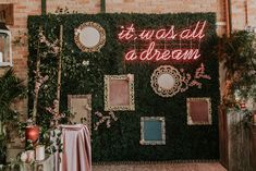 there is a neon sign that says it was all a dream in front of a green wall