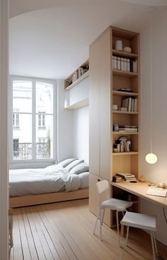 a bedroom with a bed, desk and shelves