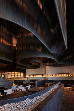 the interior of a restaurant with tables, chairs and benches lined up against the wall