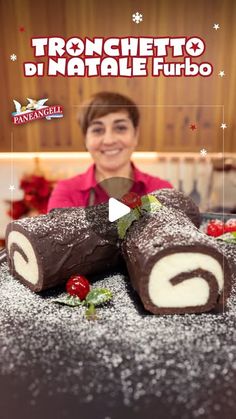 a woman standing in front of a cake with chocolate and strawberries on the side