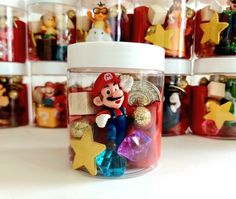 a jar filled with lots of different types of ornaments