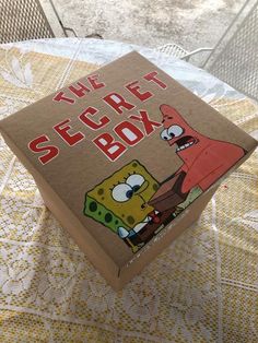 the secret box has spongebob on it and is sitting on top of a table