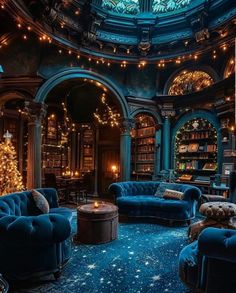 a living room filled with blue couches and christmas lights on the ceiling in front of a circular window