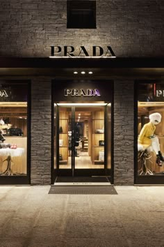 the prada storefront is lit up at night