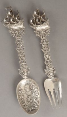 two silver spoons, one with a crown on it and the other has a fork