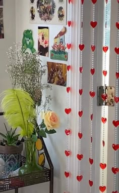 there is a vase with flowers and pictures on the wall