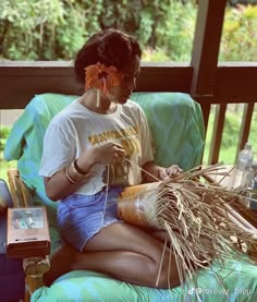 a woman sitting on a chair with food in her hand