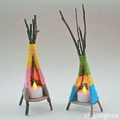 two knitted vases with candles in them and some sticks sticking out of them