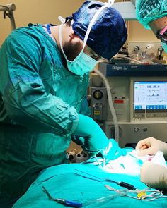 two doctors performing surgery in an operating room