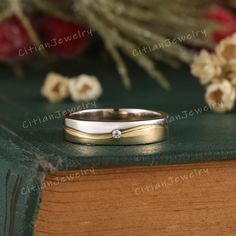 a wedding ring sitting on top of a book