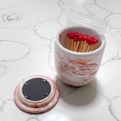 a cup filled with matches sitting on top of a counter