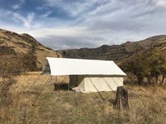 a white tent in the middle of a field