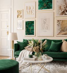 a living room with green couches and pictures on the wall