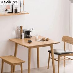 two wooden chairs sitting at a small table