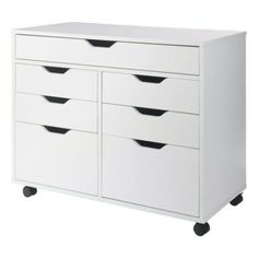 a white dresser with four drawers on wheels and two black bins in the bottom drawer