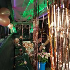 a party bus with balloons and streamers on the ceiling is decorated for a special occasion