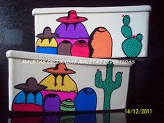 two colorful pots with cactus designs painted on the sides and one has a hat on it