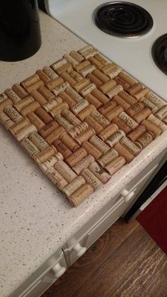 a cork coaster sitting on top of a kitchen counter next to a stovetop oven